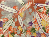 7967-Close-up of a colorful floral and leaf pattern on fabric.