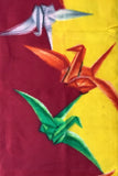 8126: 1930s Japan Meisen Silk closeupm middle -A colorful abstract artwork featuring three origami crane-like shapes in white, orange, and green, set against a split background of deep red and bright yellow.