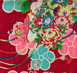 8129:  cloeup flowers, cords, drum 1930s Japan Ceremonial GIrls kimono deadstock silk fabric:  of a Japanese-style floral fabric pattern on a deep red background, featuring large pink and turquoise flowers with smaller multicolored blossoms and green leaves