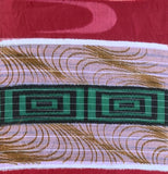 8132: A close-up of top, a woven textile pattern featuring a burundy=red top section, a central white band with a green geometric nested rectangles stripe, and gold wavy lines on a light background.