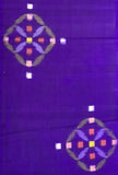 8158:1930s Japan Meisen Silk Hanabishi A close-up of a purple textile or fabric with two matching geometric motifs near the top-left and bottom-right. Each motif contains small colored squares and curved shapes in pink, orange, yellow, green, and lavender on a purple background.