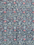 8111: A close-up of a repeating ornamental diamond-medallons grid pattern featuring pink floral motifs and swirling vine details over a muted blue-gray background.