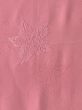 81132: 1980s Japan Kimono Silk A close-up of a pink textured fabric with subtle tonal  Japanese maple leaf patterns.