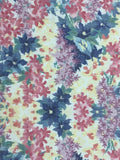 8116 1980s Japan Tsumugi Silk, closeup 1 view  a floral fabric pattern featuring pink, purple, and blue flowers with green leaves on a pale yellow background.
